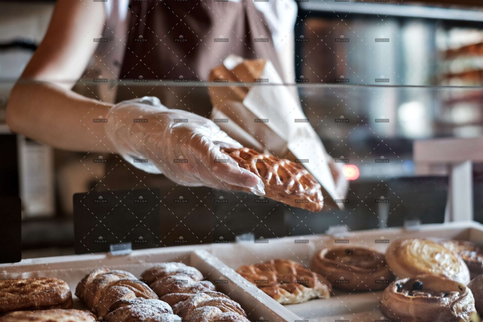 demo-attachment-646-op_european-woman-sells-in-bakery-putting-bread-in-48BERHZ